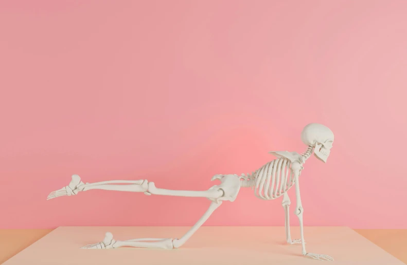 a skeleton is lying down on a pink background