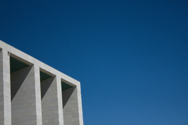 a building stands tall with a bird flying close by