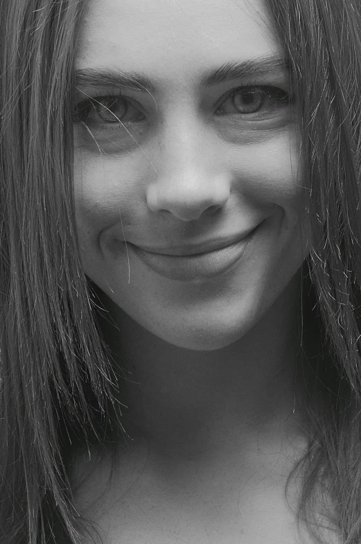 a young woman in black and white smiling at the camera