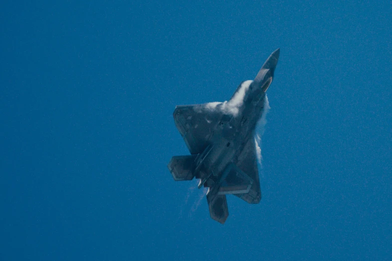 a fighter jet flying high up in the sky