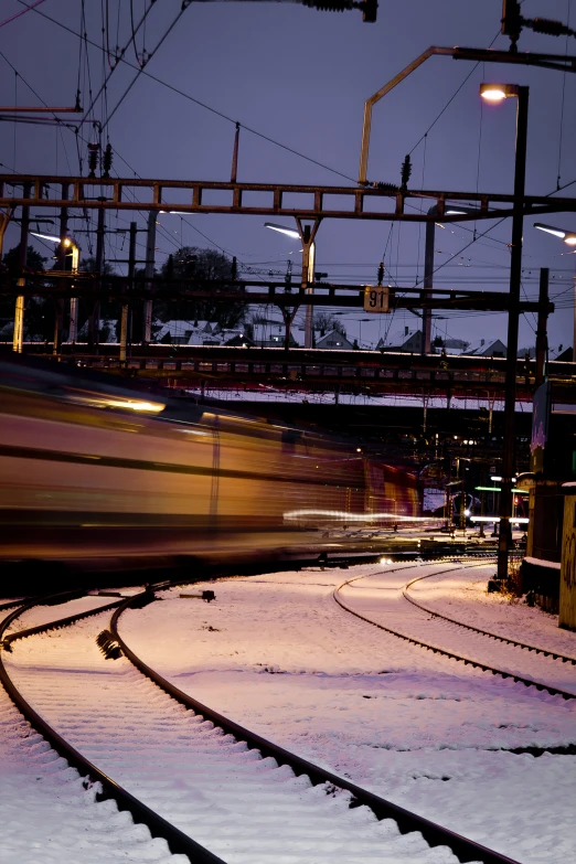 a rail line with snow on the ground