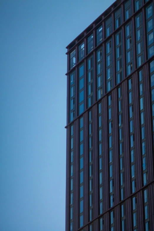 an airplane flies low above the windows of a skyscr