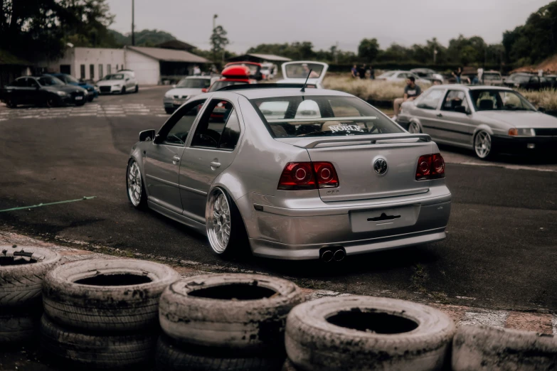 the car is parked near many used tires