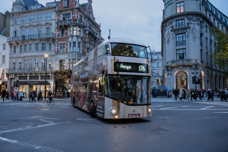 an double decker bus turning onto a busy street