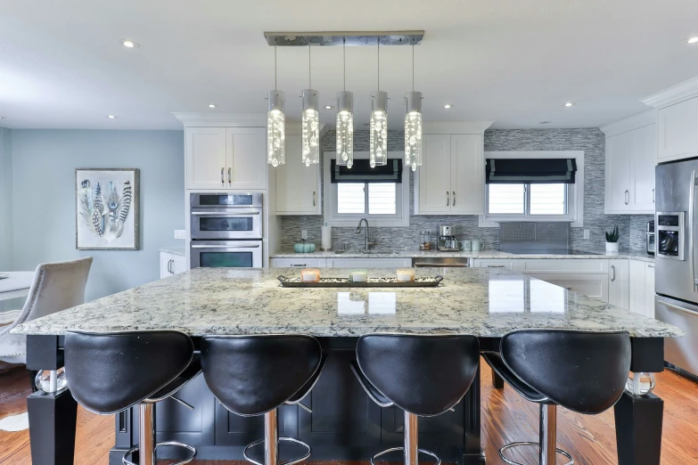 a kitchen with many chairs and a sink