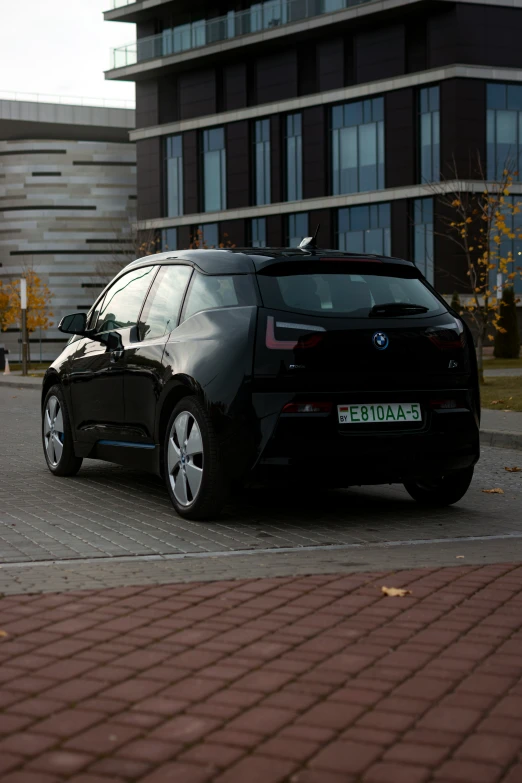 an black car parked in front of a tall building