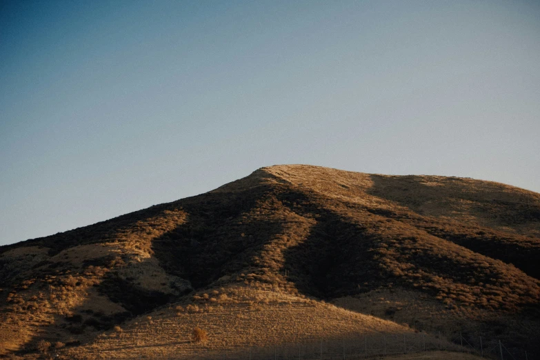 some hills with trees on each side and a blue sky above