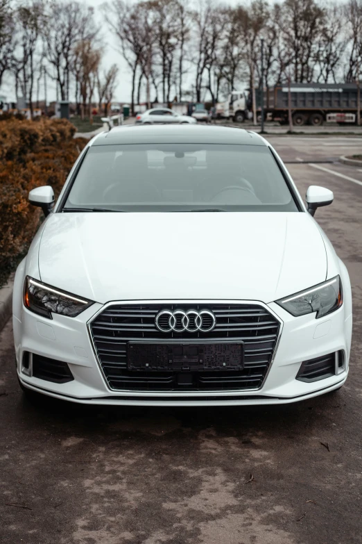 an empty parking lot with a white car parked