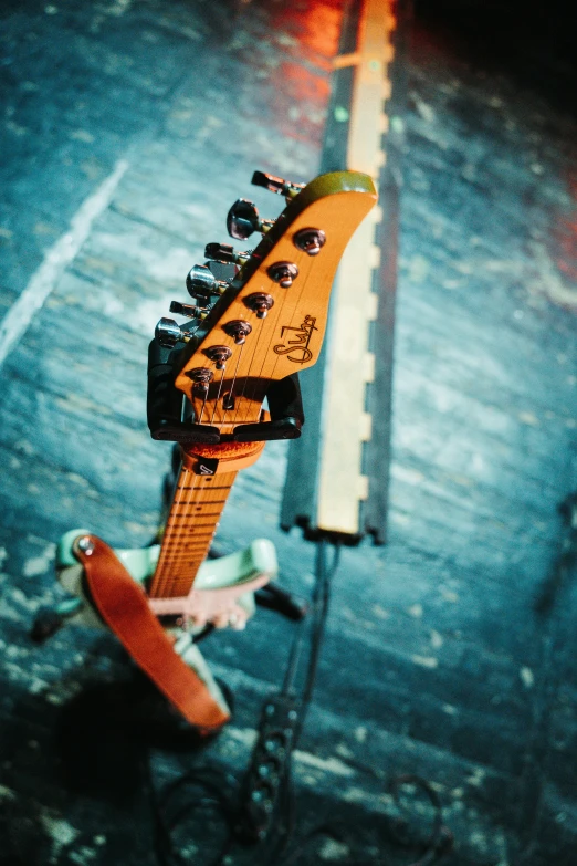 an electric guitar is laying on a pole