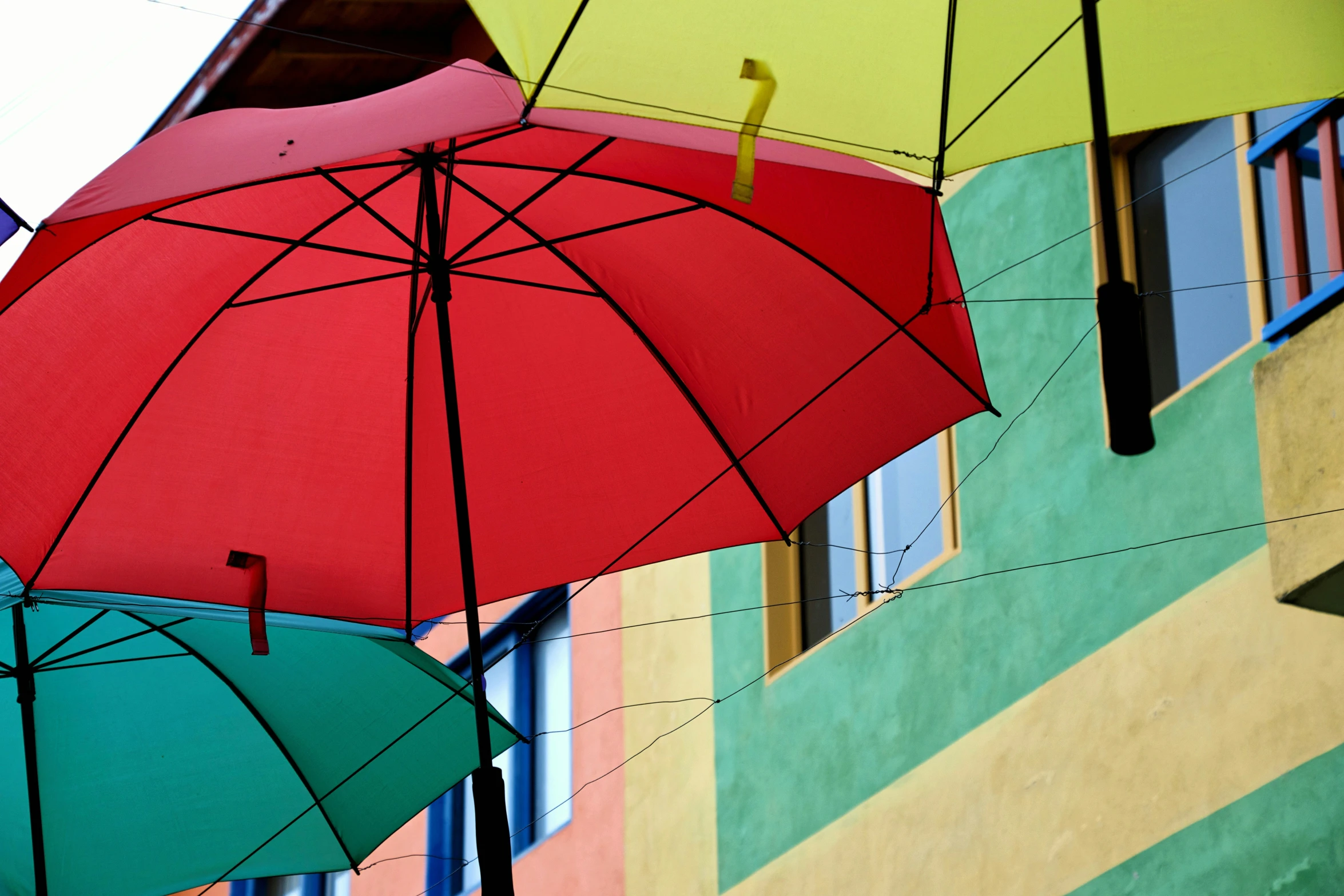 four different colored umbrellas next to each other