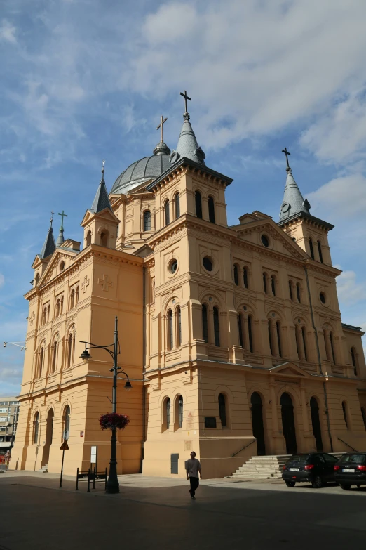 a large building with many towers near a street