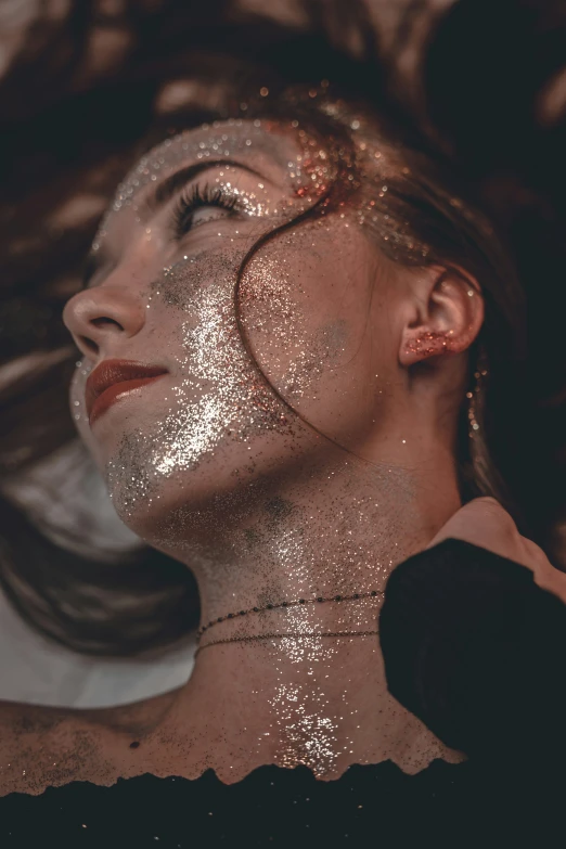 woman with silver glitters covering her face