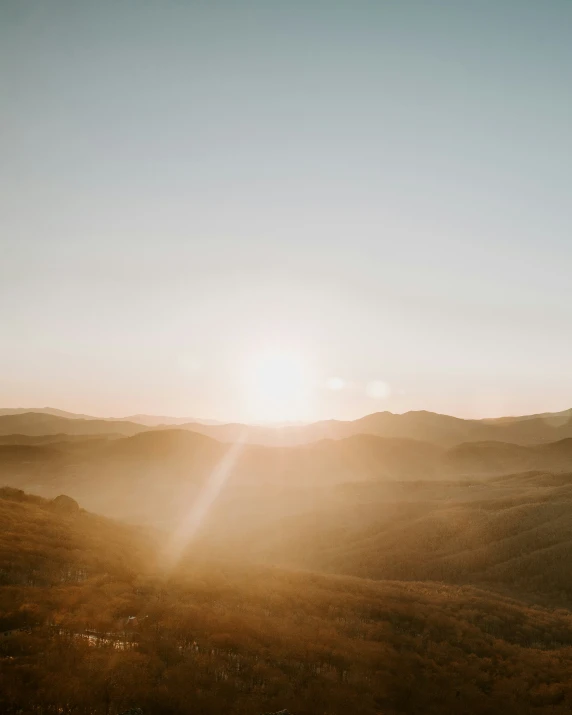 an orange sunset over a vast plain and mountains