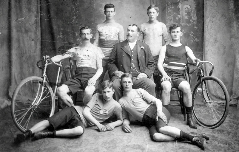several men are posing with bicycles in this old po