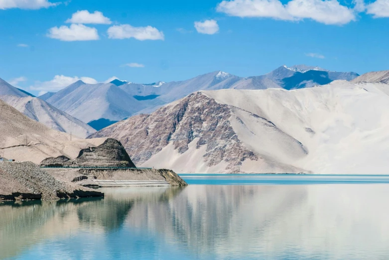 some mountains in the distance near water