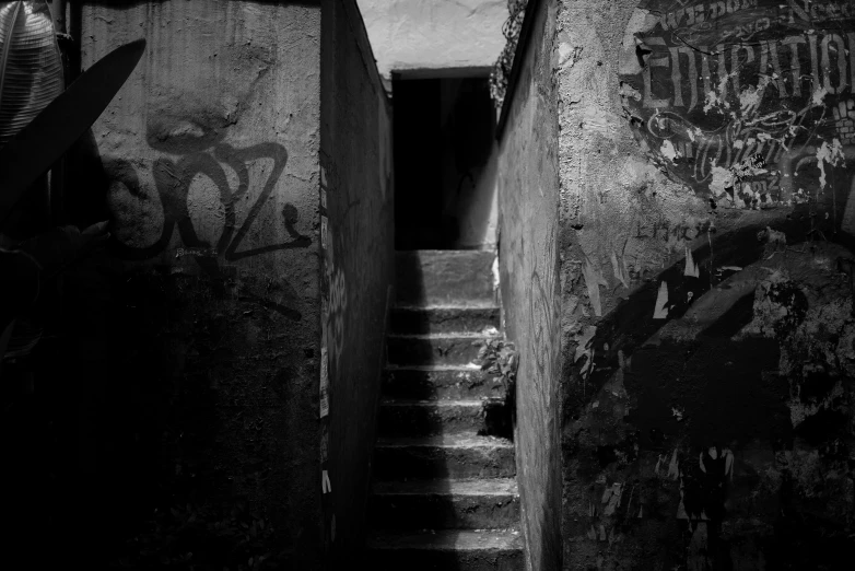 black and white image of graffiti on a wall near steps