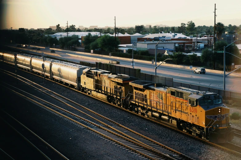 a train traveling past a bunch of houses on top of train tracks