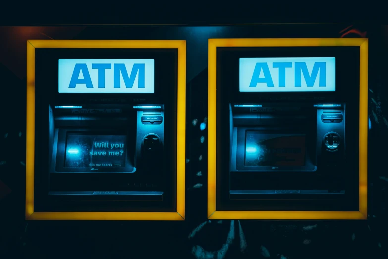 two atm machines have the word mta painted on them