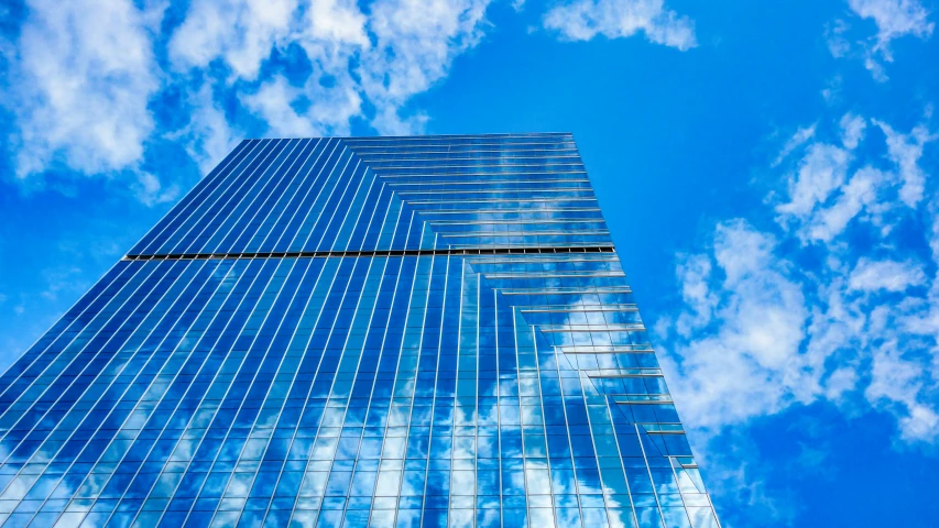 an upward view of the top of a tall skyscr building