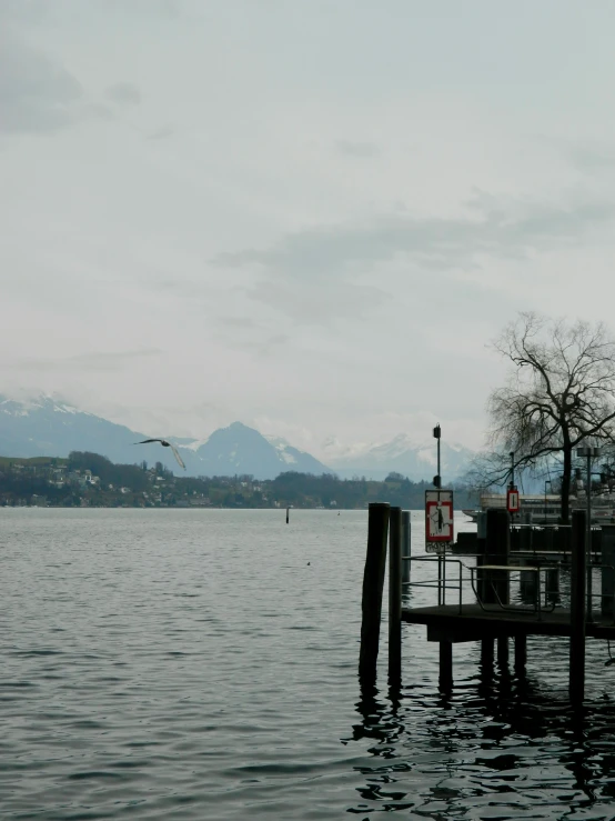 an airplane is taking off from the dock of a lake