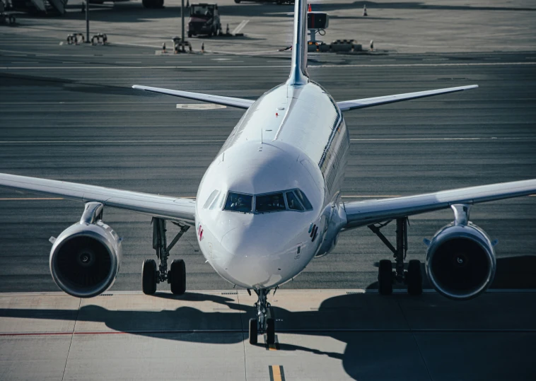 the front view of a jet airliner on runway