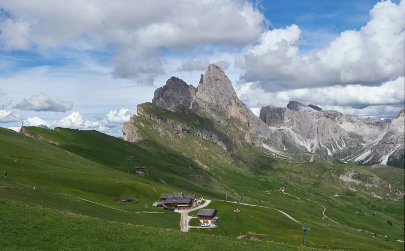 a large rocky mountain range with a building and houses