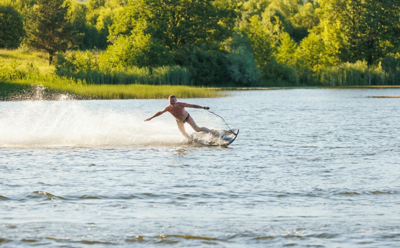 a person riding a board on a wave in the water
