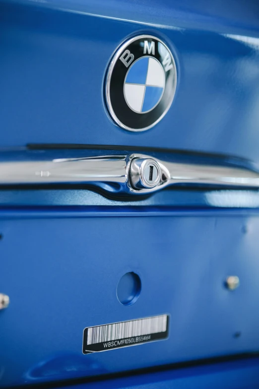 a close up of the emblem and logo on a blue suitcase