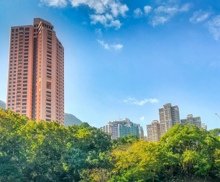 buildings in a park with trees and the water