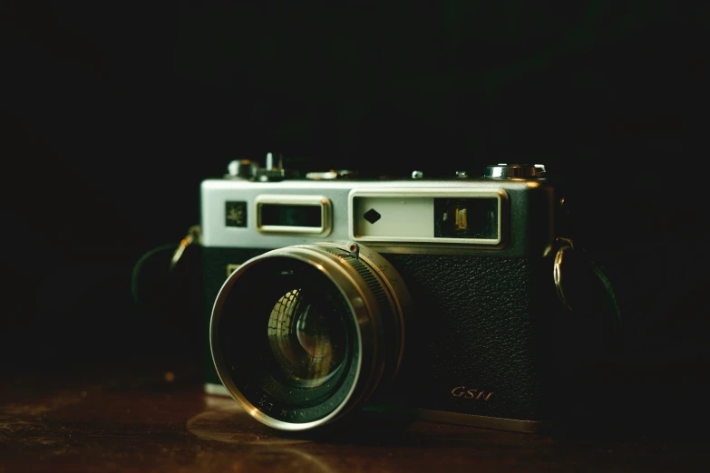 an old camera is resting on a table