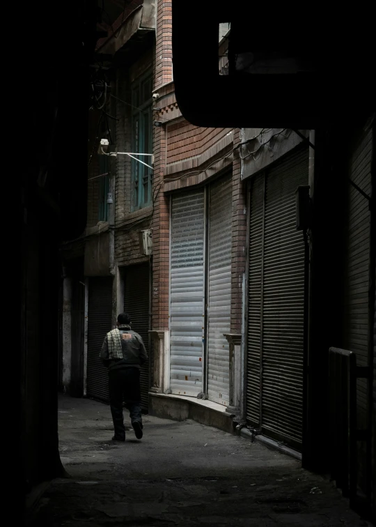 a person walking down a street next to buildings