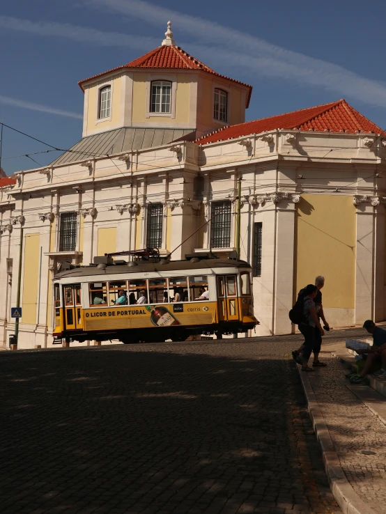 a trolley that is driving past a large building