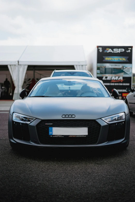 a sports car on a street with other cars in the background