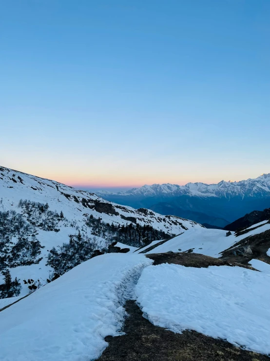 the trail is up above a snowy hillside