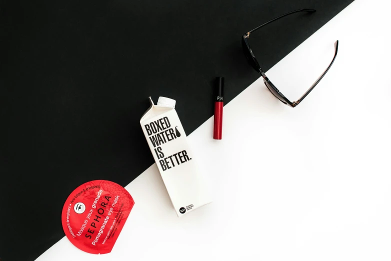 items on black and white surface with sunglasses