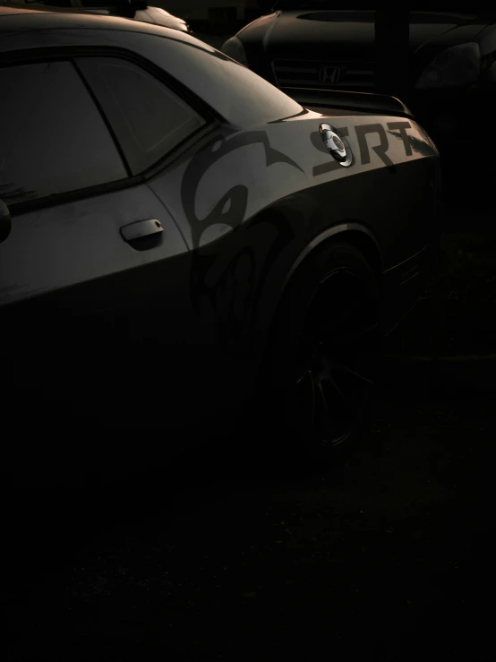 a car parked in the dark with its wheels off