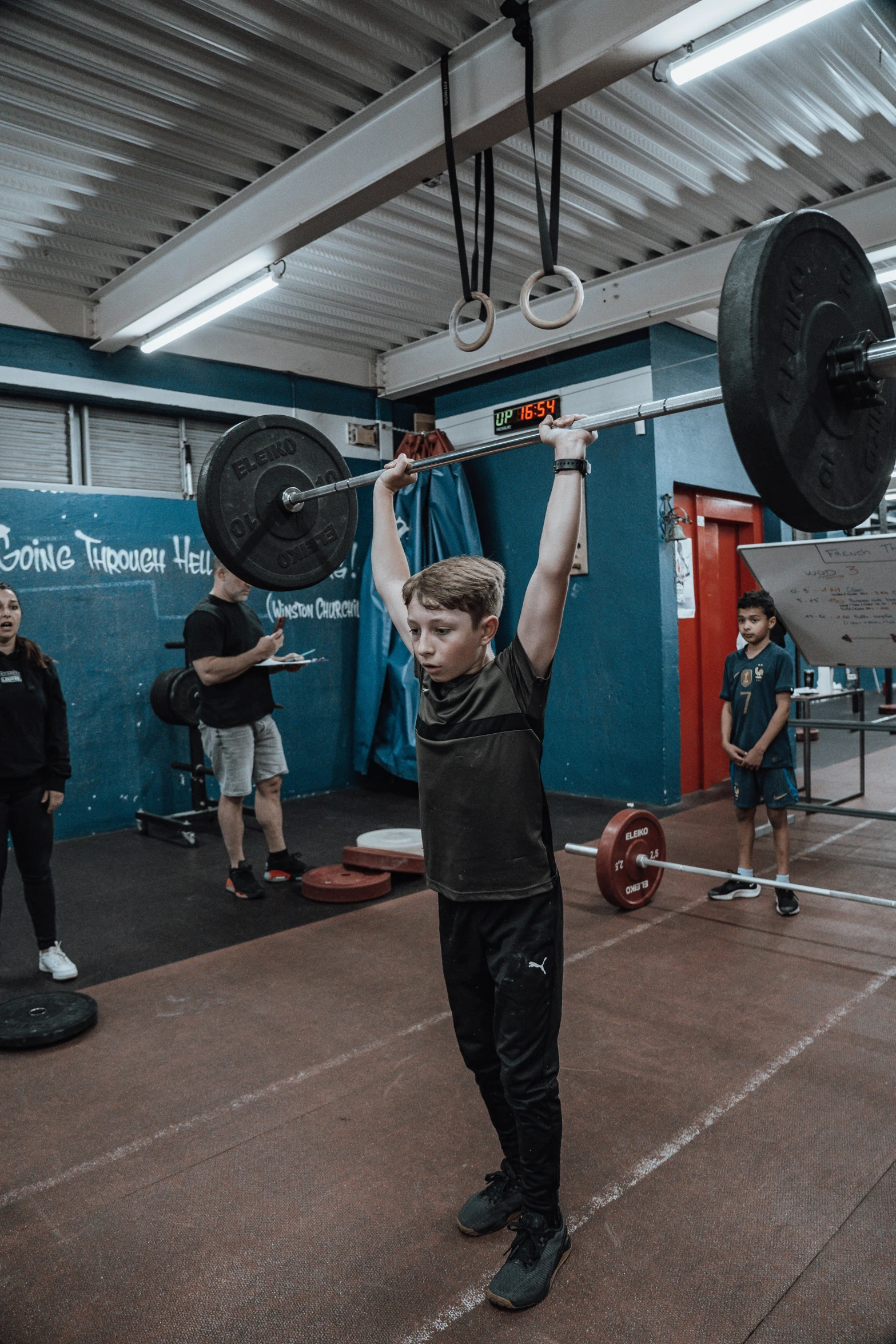 the man is lifting two plates in the air