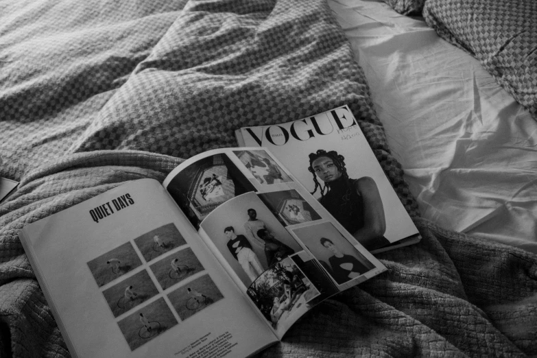 a person reading in bed with blankets and sheets