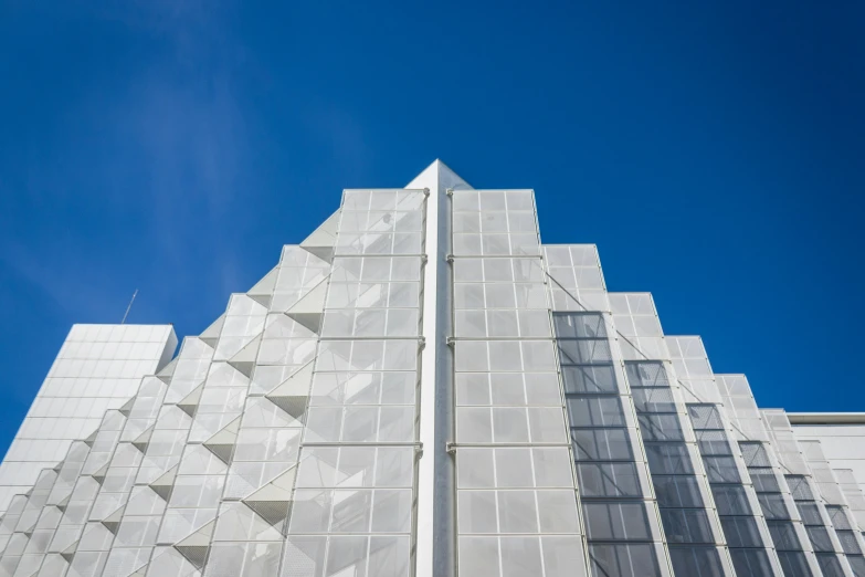 the sky is clear in color for this tall white building