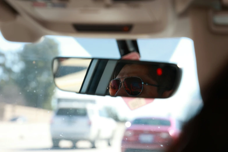 man with sunglasses and hat driving on his way to work