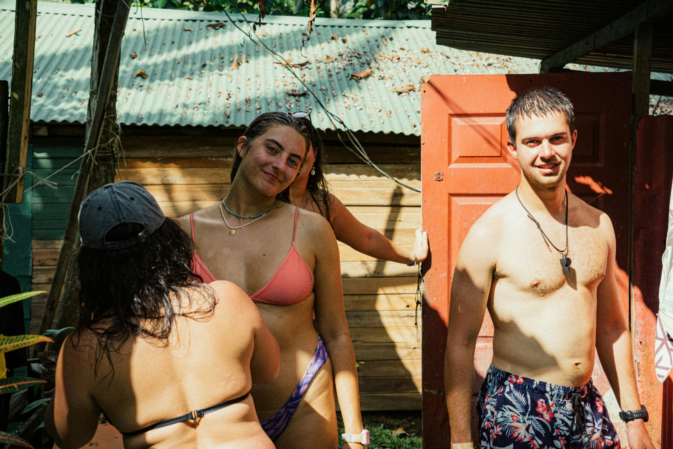 two men and a woman are in their bathing suits