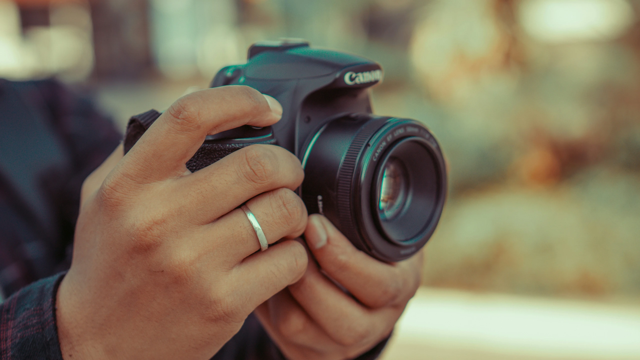 a man holding a camera taking a picture