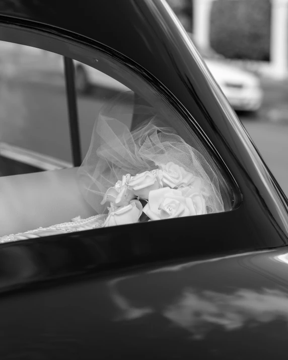 bride's bouquet sitting in her car window