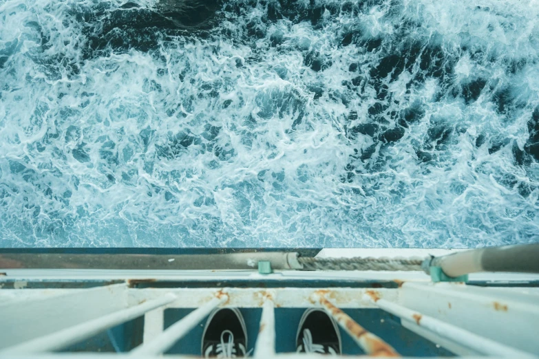 looking down at the ocean from inside a boat