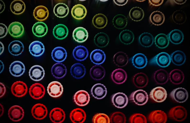 an assortment of different colored bottles in a box