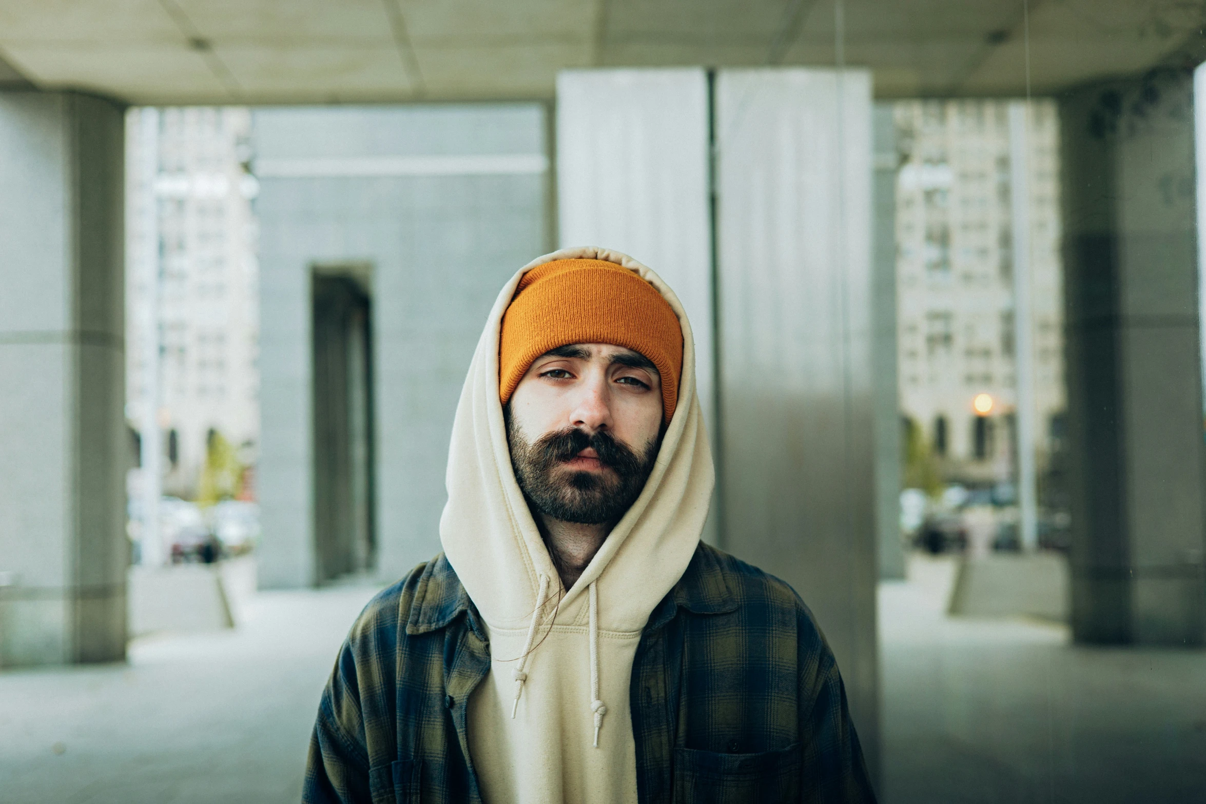 a man with a hoodie and an orange hat on