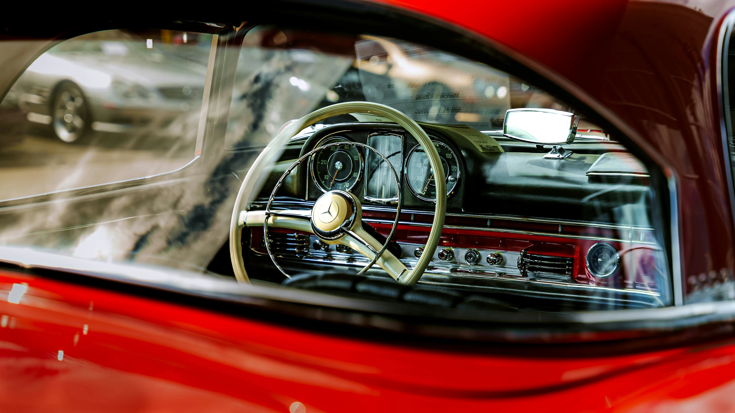 a red sports car with a clock on the dashboard