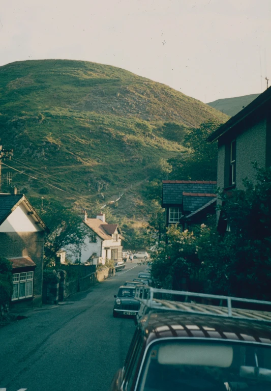 the view from a small hill looking down a town street