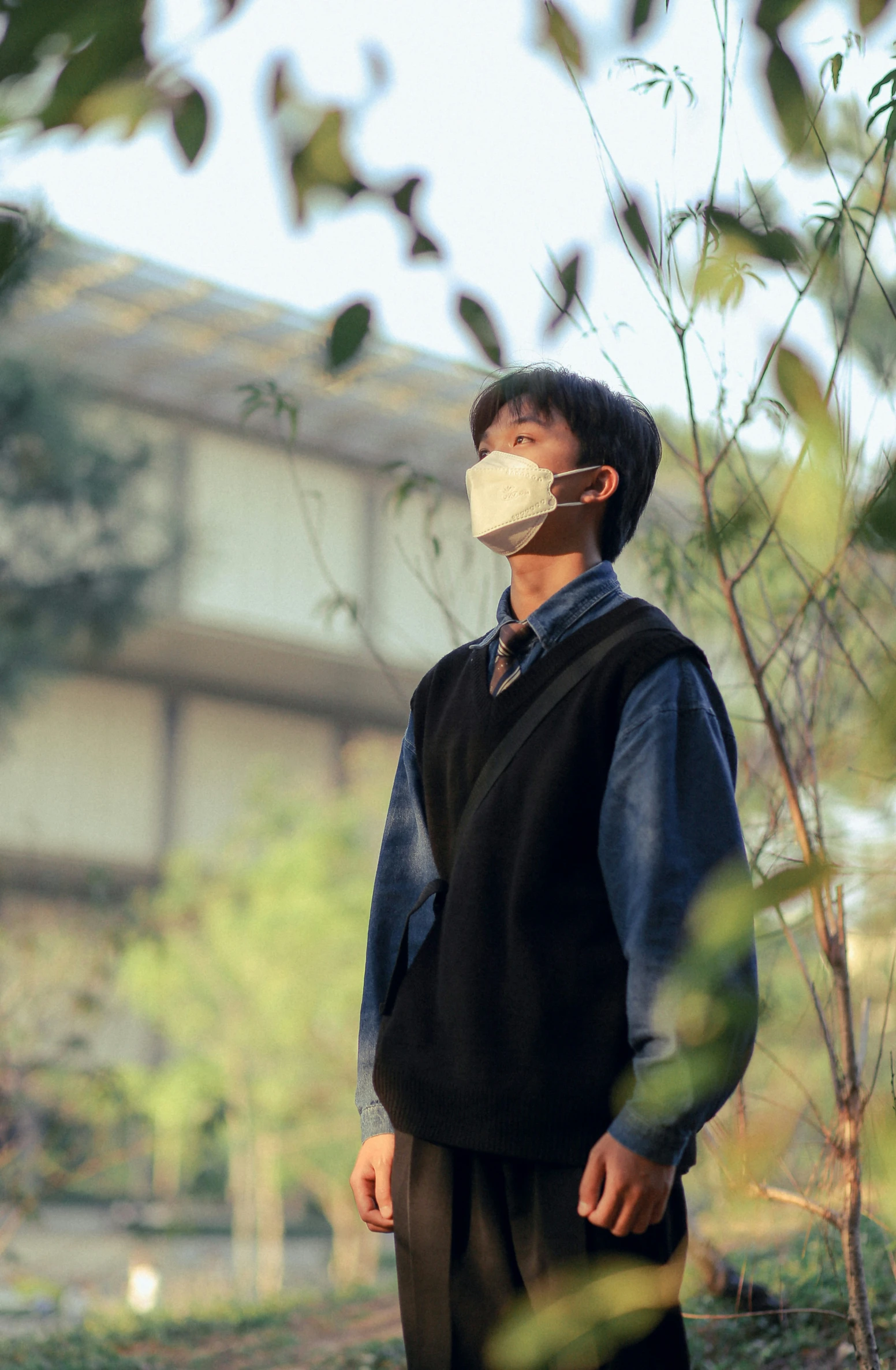 a man wearing a face mask in front of a building