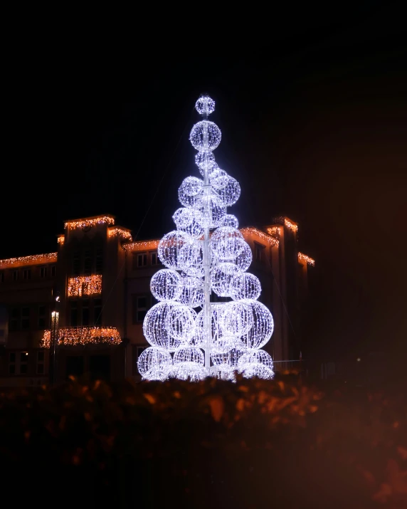 a lit up christmas tree with lights on it